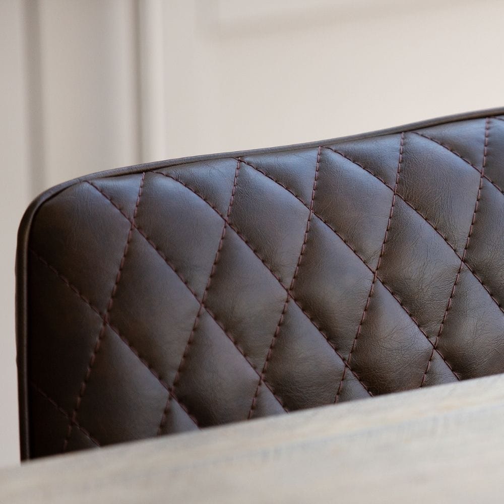 dark brown faux leather dining chair close up
