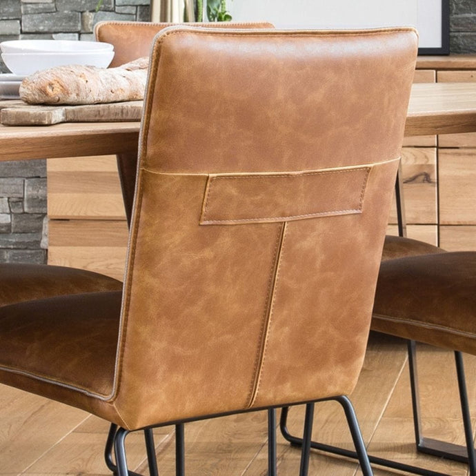 close up of tan faux leather dining chair
